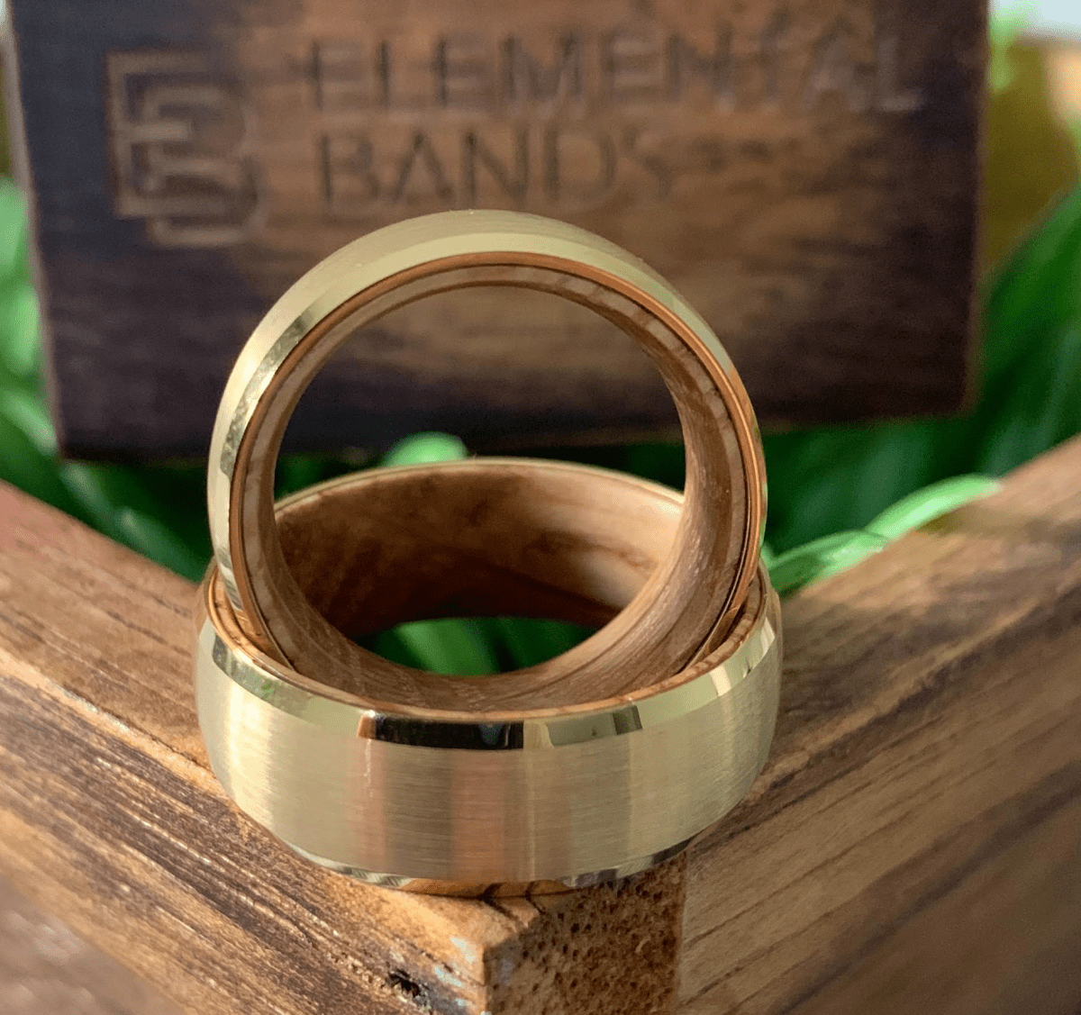 Unique Mens' Wedding Band featuring yellow gold tungsten with whiskey wood sleeve.