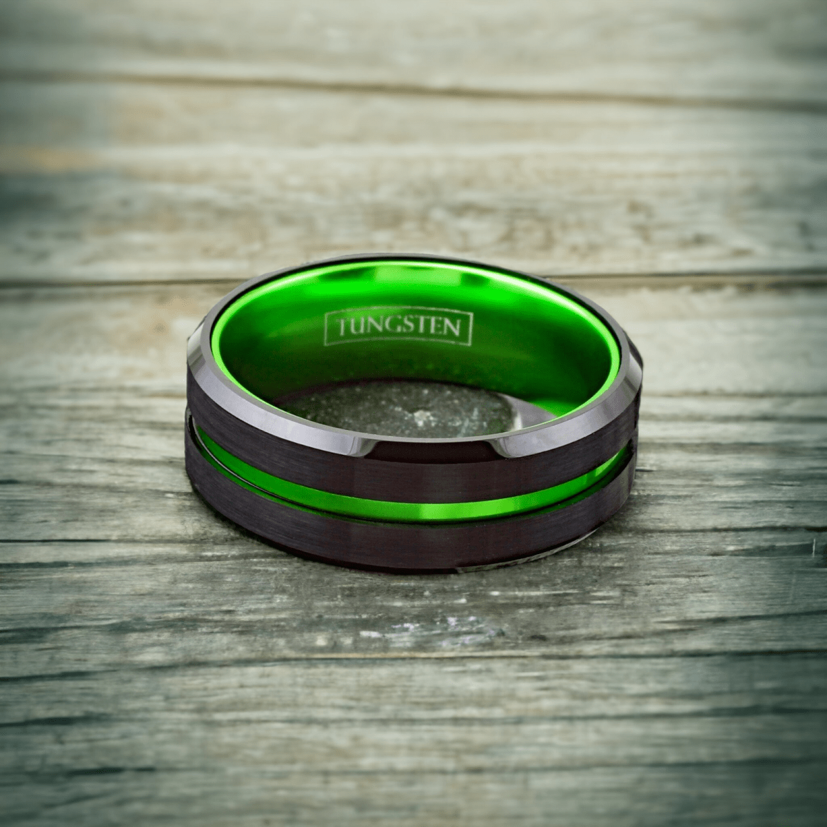 green and black tungsten ring with thin green line and black beveled edges
